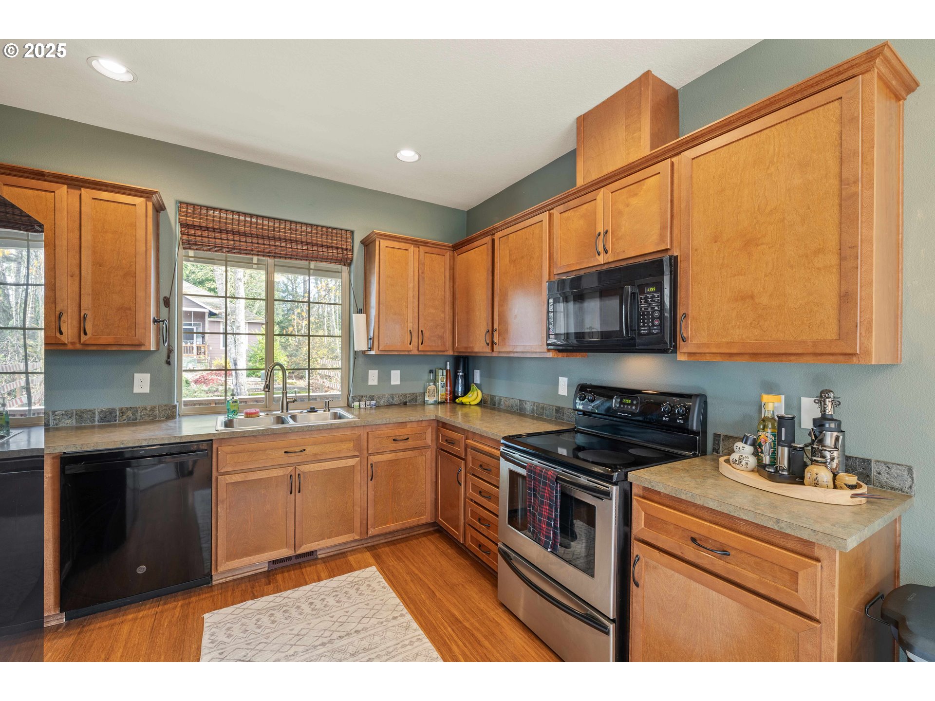 18465 Meadow Avenue Sandy, OR 97055 - Photo 14 of 43 a kitchen with stainless steel appliances granite countertop a stove a sink and a microwave