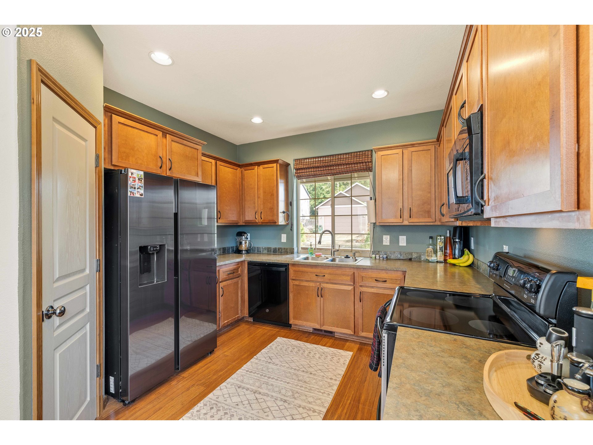 18465 Meadow Avenue Sandy, OR 97055 - Photo 15 of 43 a kitchen with stainless steel appliances granite countertop a refrigerator a sink a stove and island
