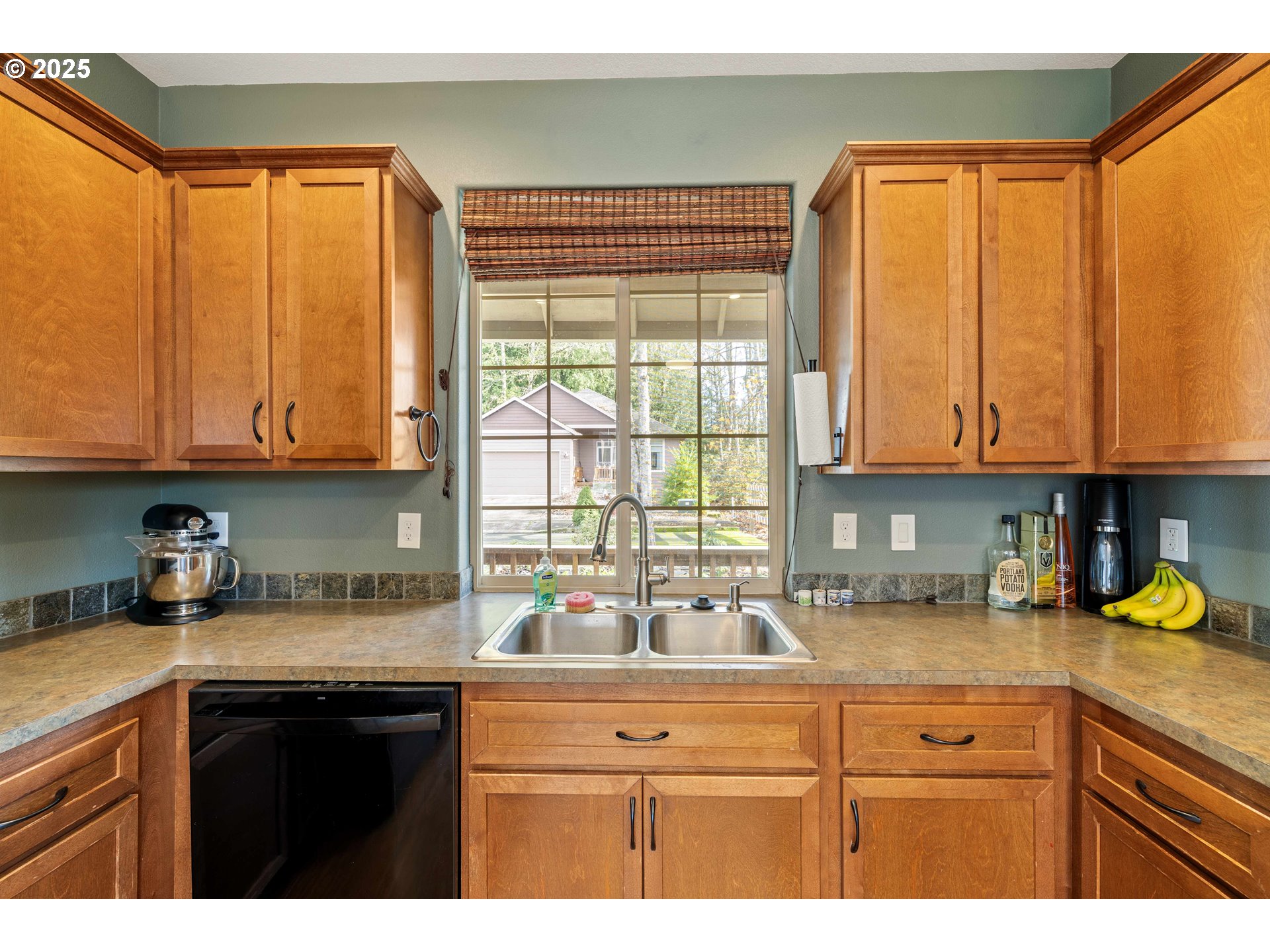 18465 Meadow Avenue Sandy, OR 97055 - Photo 16 of 43 a kitchen with stainless steel appliances granite countertop a sink a refrigerator a stove and cabinets