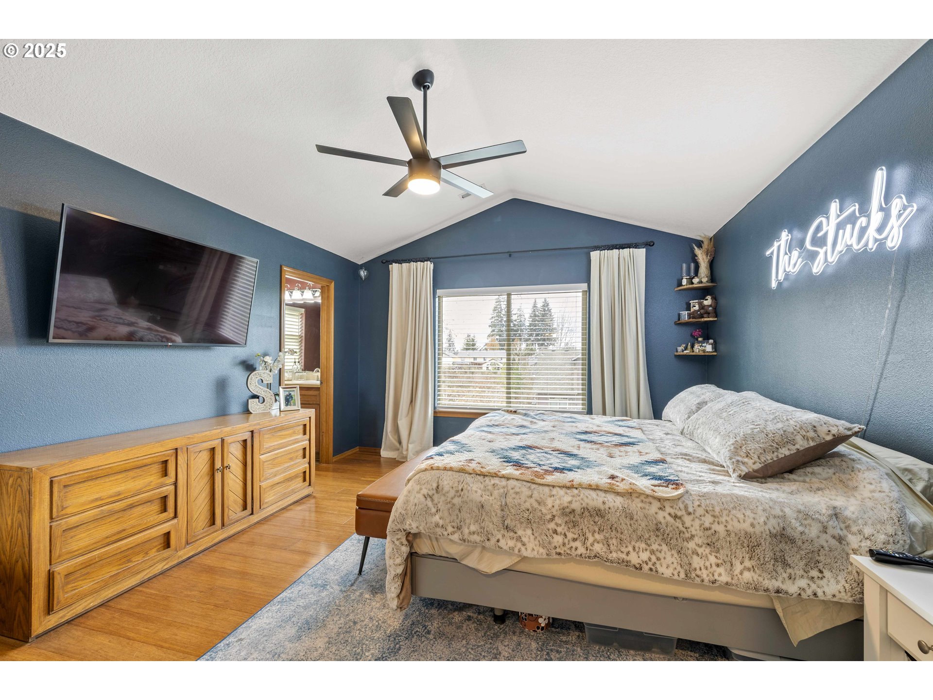 18465 Meadow Avenue Sandy, OR 97055 - Photo 18 of 43 a bedroom with a bed a mirror on dresser and a flat screen tv