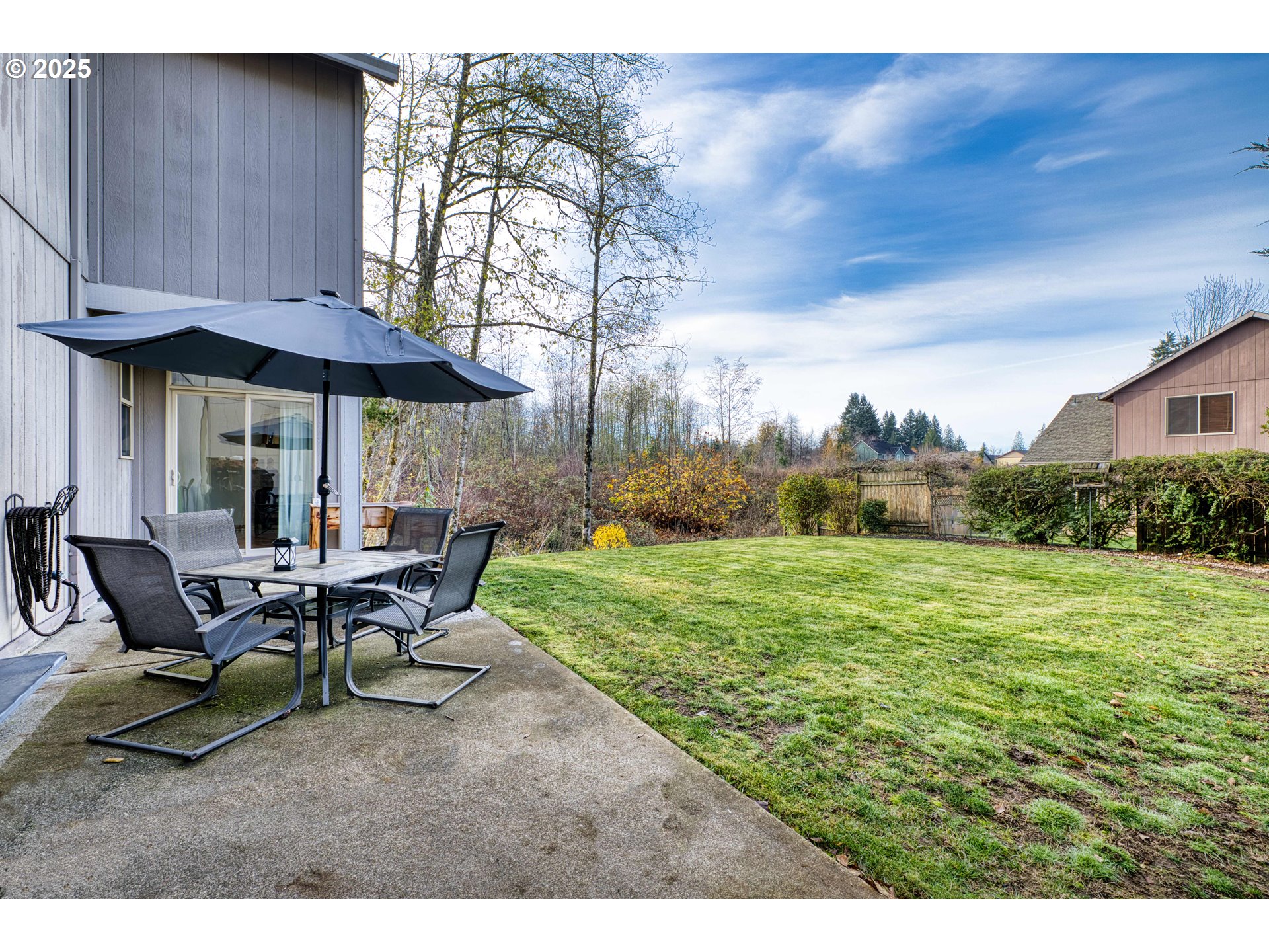 18465 Meadow Avenue Sandy, OR 97055 - Photo 36 of 43 a view of a backyard with table and chairs under an umbrella