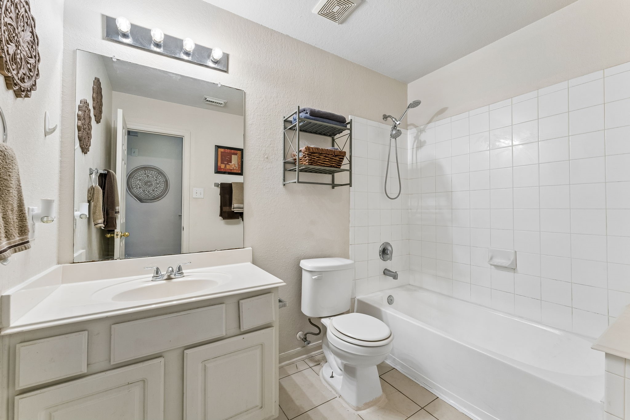 3203 Falcon Trail Drive Spring, TX 77373 - Photo 22 of 33 Clean and functional secondary bath featuring a tub/shower combination, generous vanity space and easy-care tile flooring.