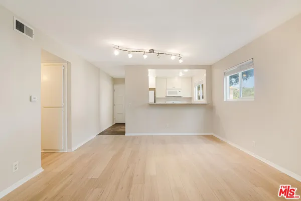 a view of an empty room with a window
