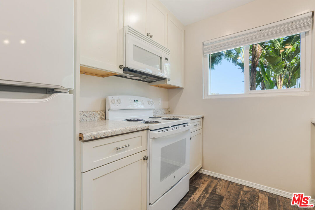 6475 Kanan Dume Road Malibu, CA 90265 - Photo 5 of 17 a kitchen with stainless steel appliances granite countertop white cabinets and a stove