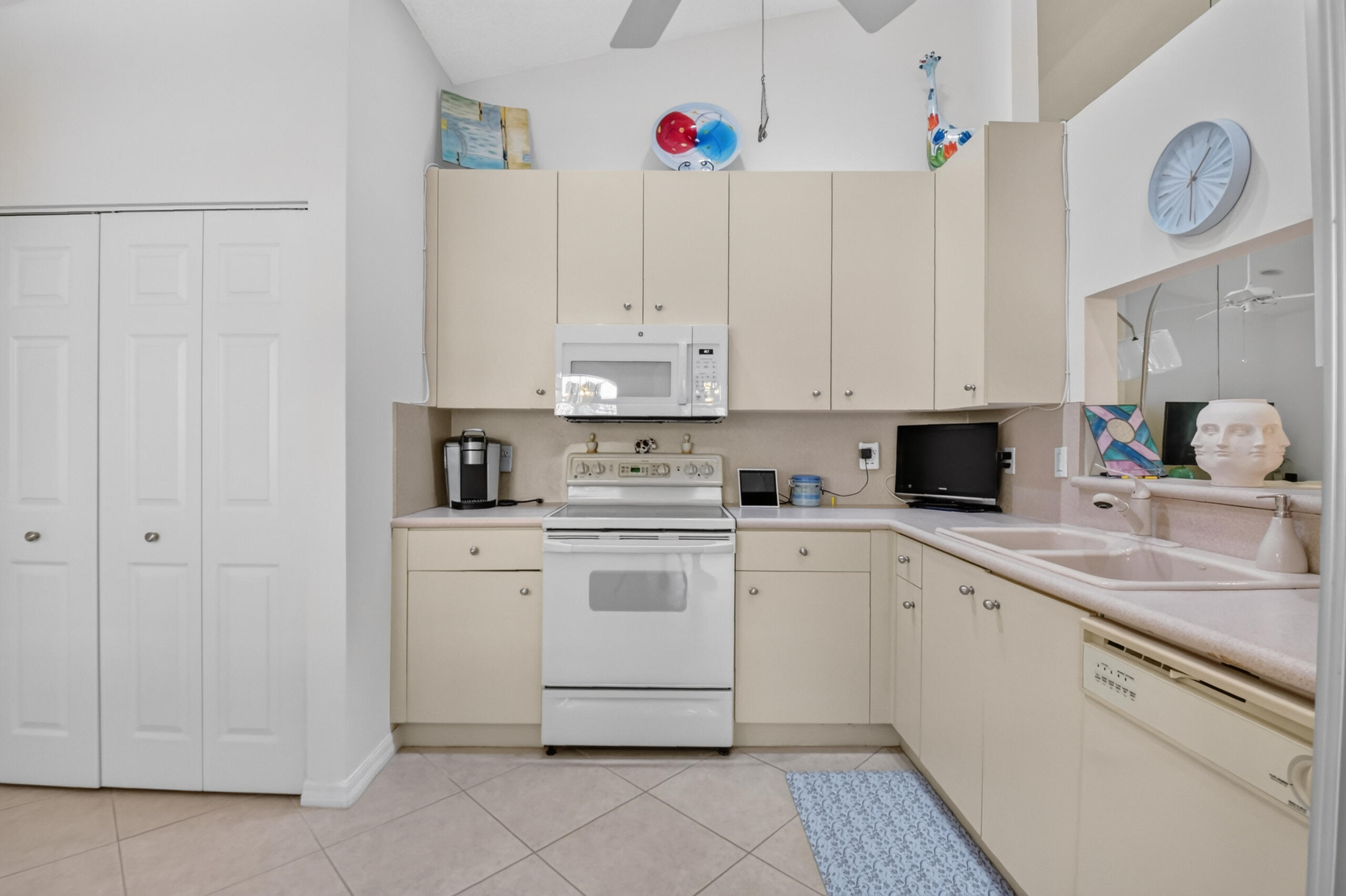 15340 Floral Club Road Delray Beach, FL 33484 - Photo 9 of 42 a kitchen with cabinets appliances and a sink