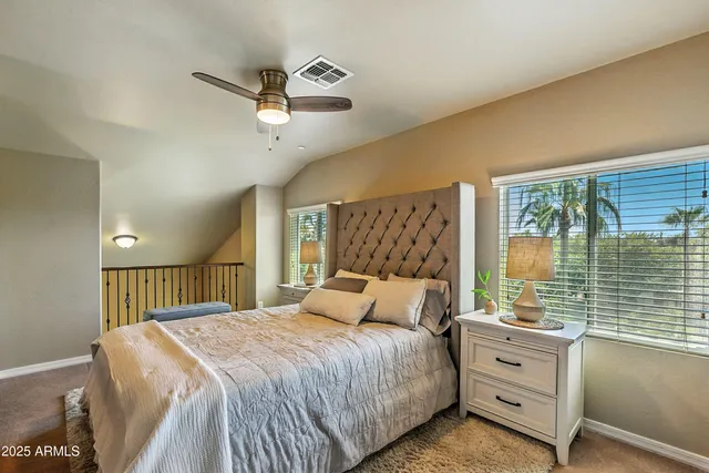 a bedroom with a bed and a large window