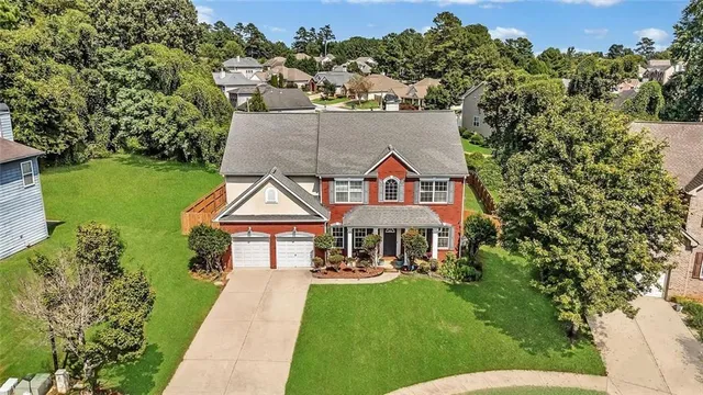 a aerial view of a house with a yard
