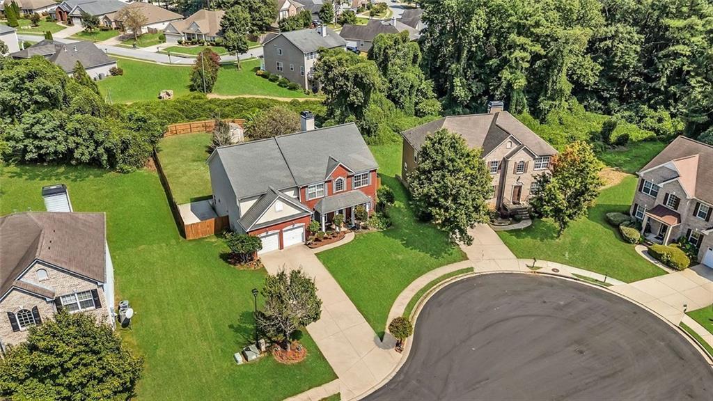 an aerial view of a house with outdoor space pool seating area and yard