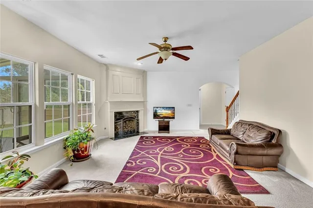 a kitchen with stainless steel appliances granite countertop a stove a sink a refrigerator a dining table and chairs with wooden floor