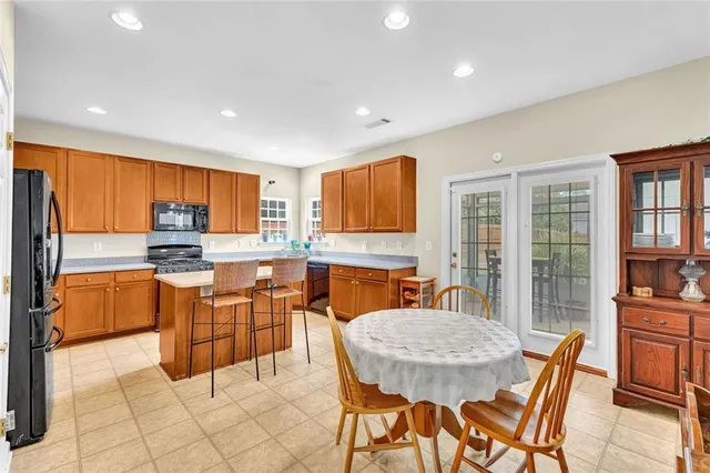 a kitchen with stainless steel appliances granite countertop a sink and a refrigerator