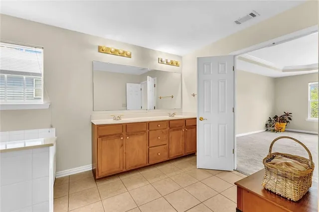 an empty room with a window and a ceiling fan