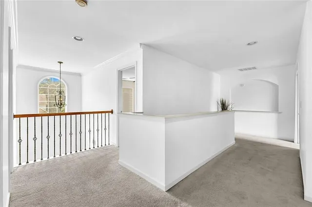a spacious bathroom with a double vanity sink toilet mirror and shower