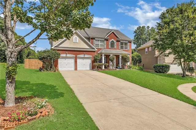 a front view of a house with a yard