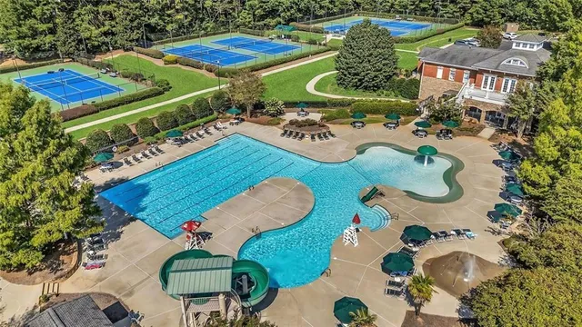 an aerial view of a house with a yard and lake view