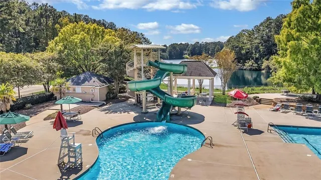 a kitchen with stainless steel appliances granite countertop a stove a sink dishwasher and a refrigerator with wooden cabinets