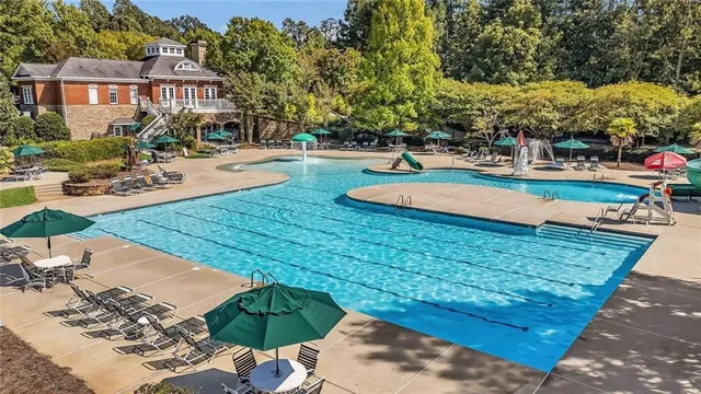 a kitchen with stainless steel appliances wooden floor and a refrigerator