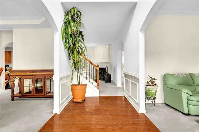 a spacious bedroom with a bed and table chair