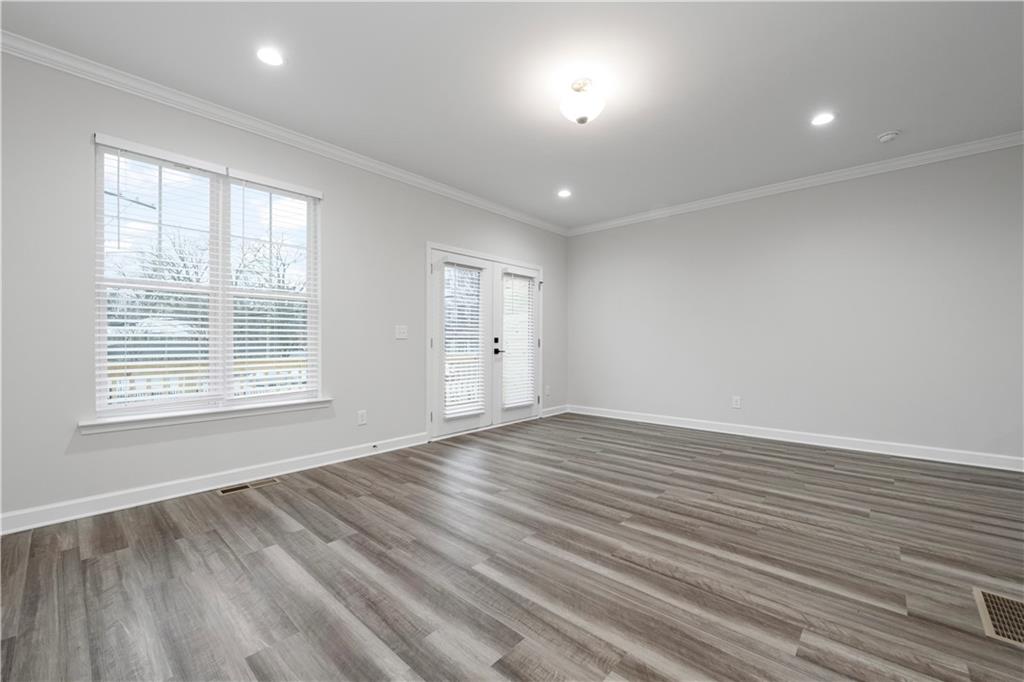 2010 Main Street Northwest Atlanta, GA 30318 - Photo 13 of 37 an empty room with wooden floor and windows