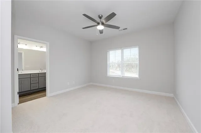 a view of empty room with ceiling fan