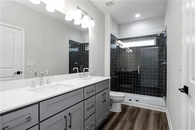 a bathroom with a sink a light fixture and a mirror