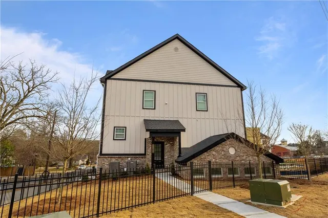 a view of a house with wooden fence