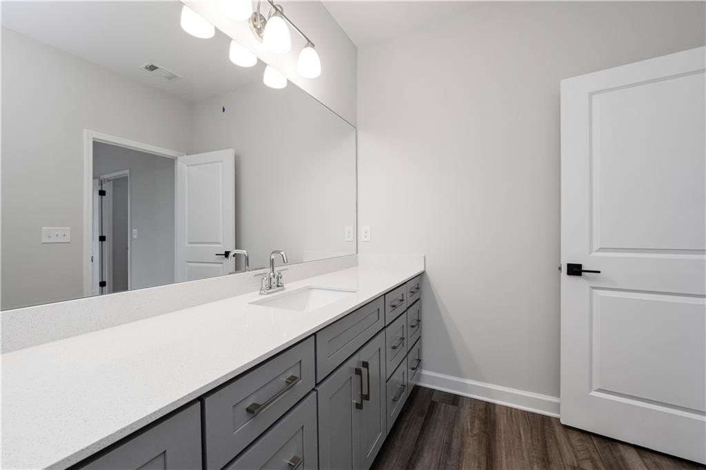 2010 Main Street Northwest Atlanta, GA 30318 - Photo 24 of 37 a bathroom with a sink a vanity and a mirror