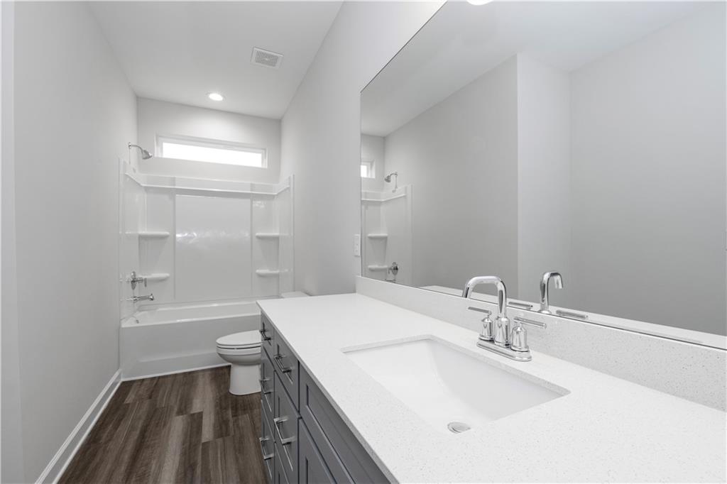 2010 Main Street Northwest Atlanta, GA 30318 - Photo 25 of 37 a bathroom with a sink a toilet and shower