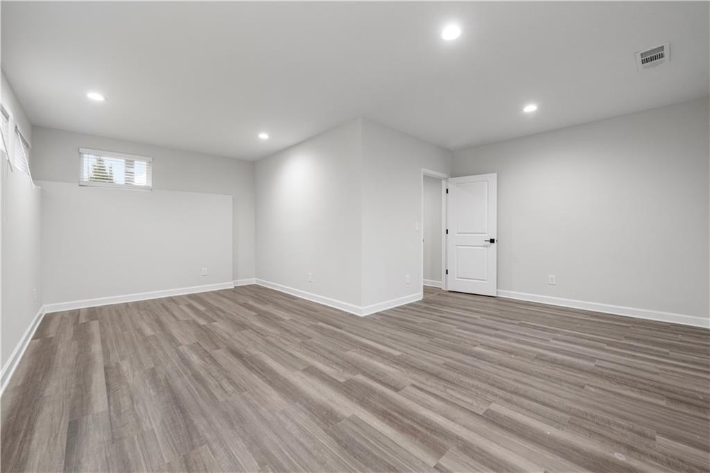 2010 Main Street Northwest Atlanta, GA 30318 - Photo 30 of 37 a view of an empty room with wooden floor and a window