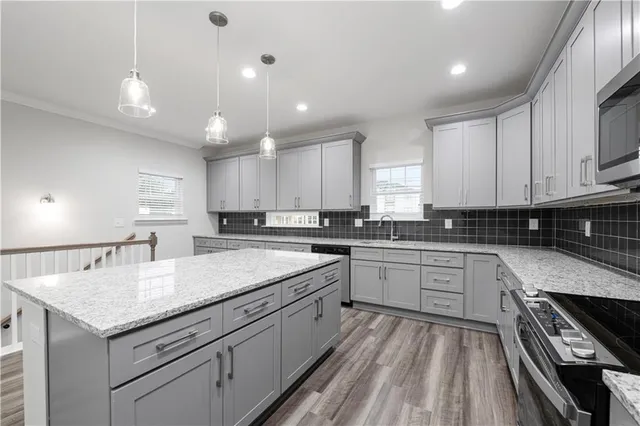a kitchen with a white center island and cabinets