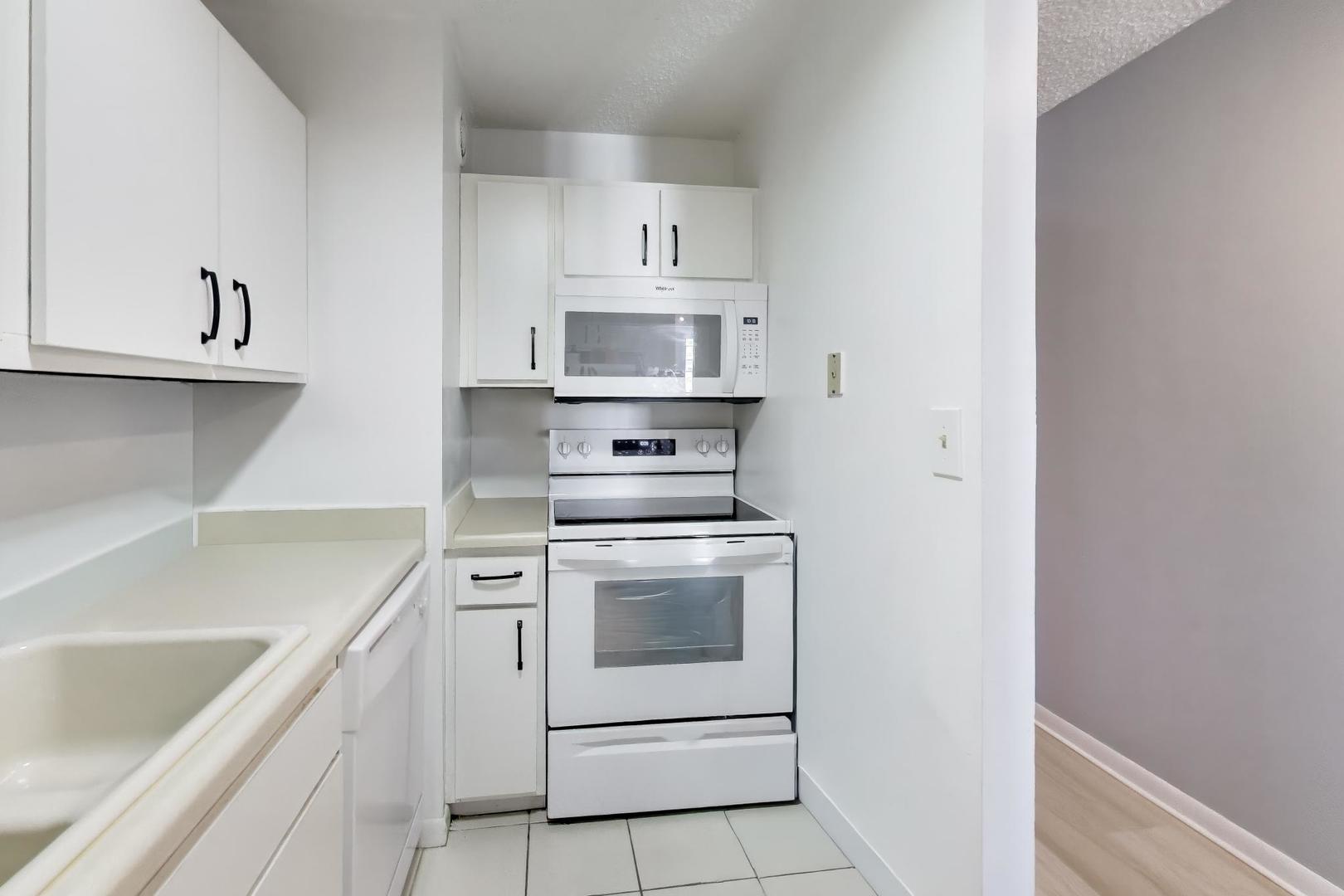 1122 North Clark Street, Unit 3705 Chicago, IL 60610 - Photo 12 of 38 a kitchen with a stove sink and cabinets