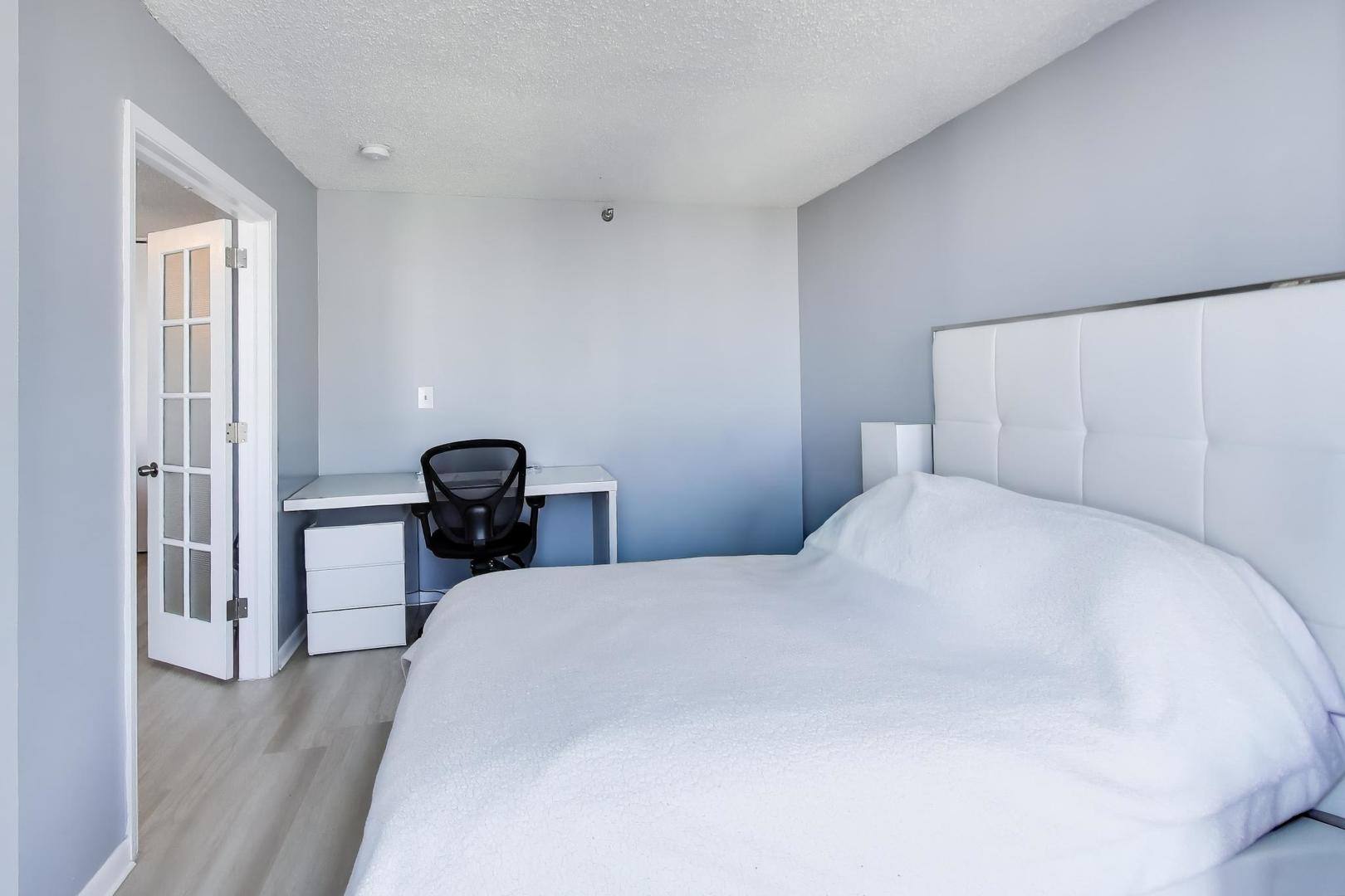 1122 North Clark Street, Unit 3705 Chicago, IL 60610 - Photo 16 of 38 a bedroom with a bed and a table in it