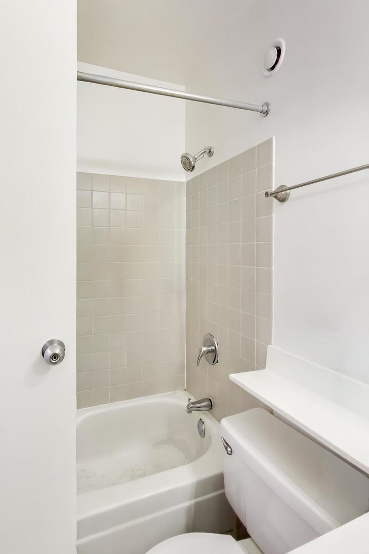 1122 North Clark Street, Unit 3705 Chicago, IL 60610 - Photo 20 of 38 a bathroom with a shower and a bathtub