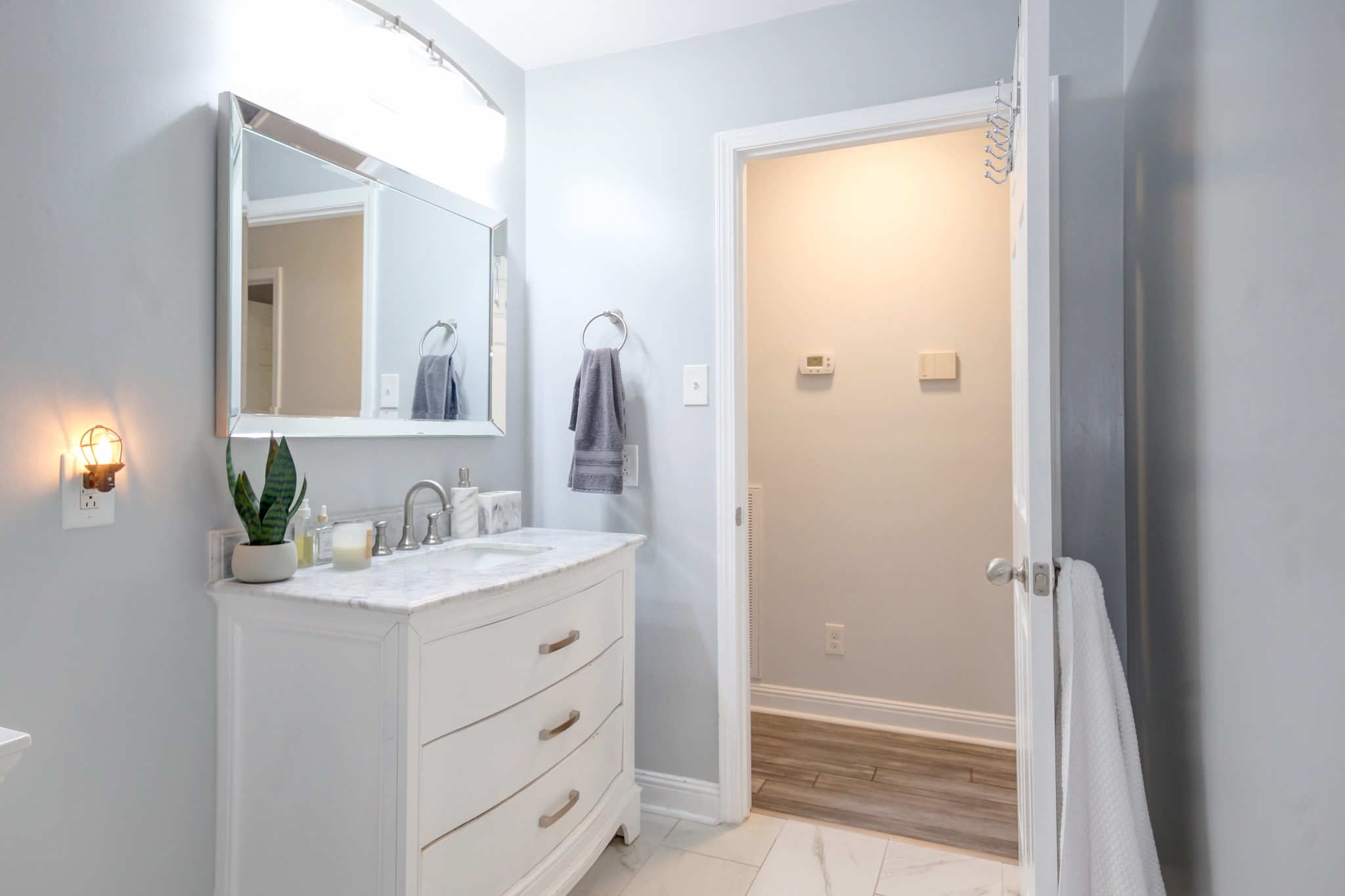 4141 Sango Road Clarksville, TN 37043 - Photo 27 of 57 a bathroom with a sink a vanity a mirror and a window
