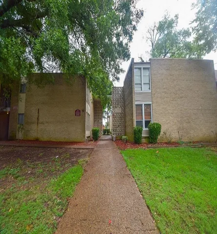 a pathway of a house with a yard