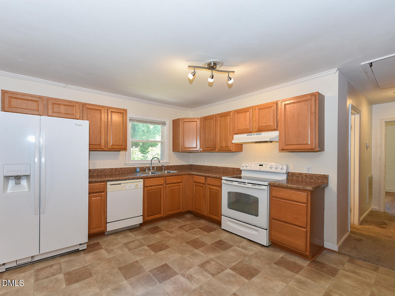 1703 St Patrick Drive Raleigh, NC 27603 - Photo 7 of 29 a kitchen with stainless steel appliances granite countertop a stove top oven sink and cabinets
