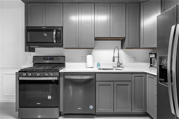 a kitchen with granite countertop stainless steel appliances and wooden cabinets