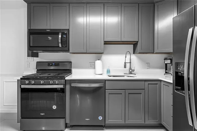a kitchen with granite countertop stainless steel appliances and wooden cabinets