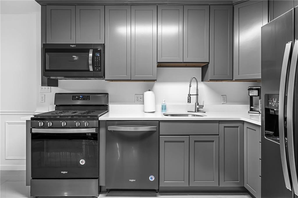 1509 Kenzie Road Pittsburgh, PA 15205 - Photo 19 of 25 a kitchen with stainless steel appliances granite countertop a stove a sink and a microwave