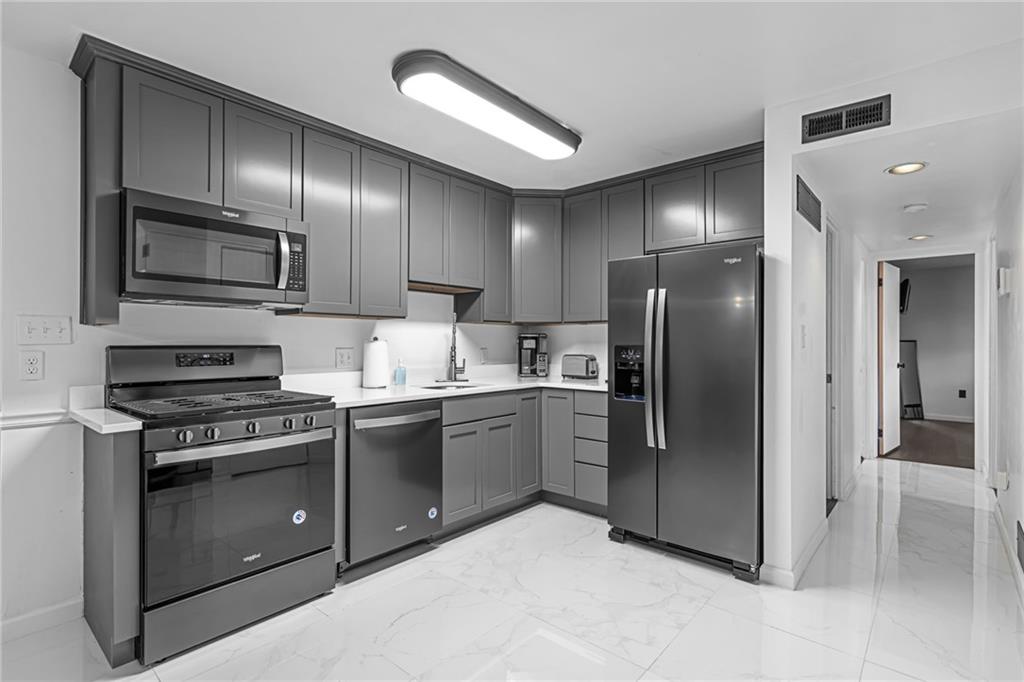 1509 Kenzie Road Pittsburgh, PA 15205 - Photo 20 of 25 a kitchen with granite countertop stainless steel appliances and wooden cabinets