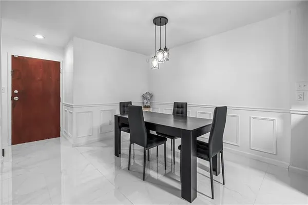 a view of a dining room with a table and chairs