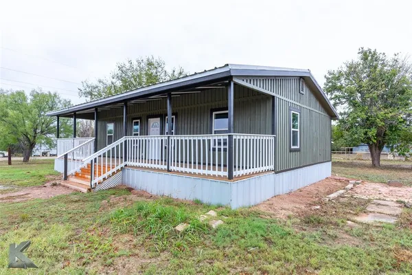 a view of a house with a yard and deck