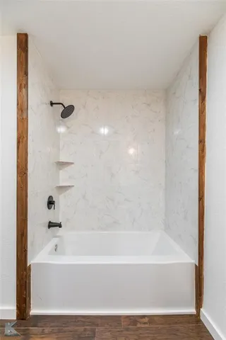 a bathroom with bathtub and shower