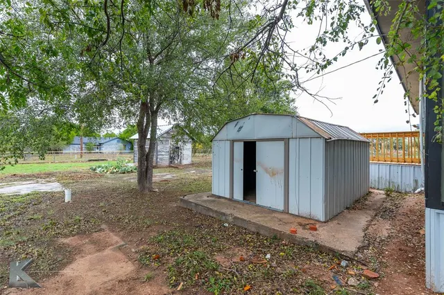 a view of a house with a yard and tree