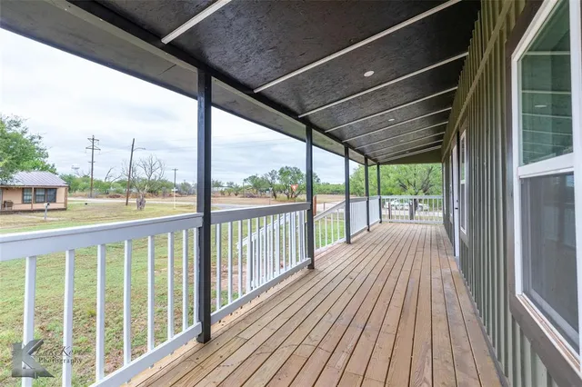 a view of a balcony with wooden floor