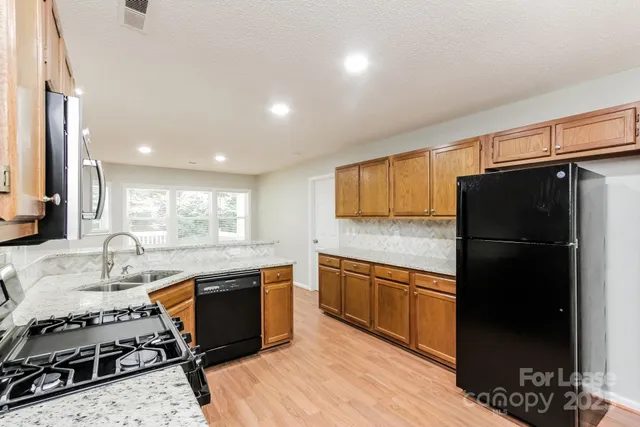 a kitchen with a sink appliances and cabinets