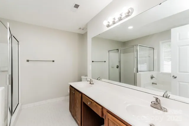 a bathroom with a sink double vanity and a mirror