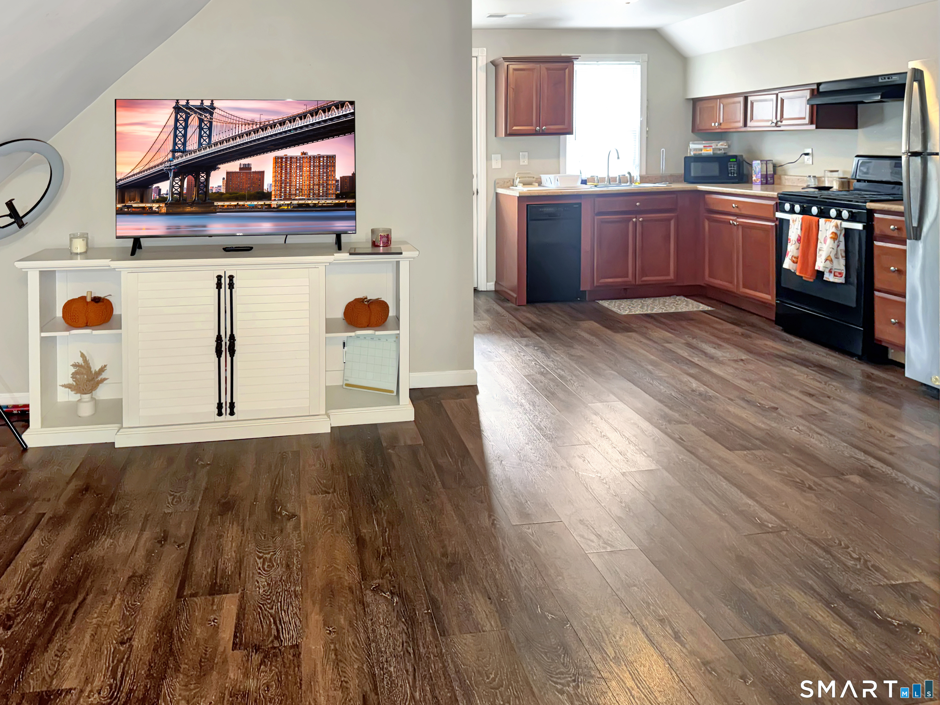 18 Columbia Street Ansonia, CT 06401 - Photo 12 of 16 a kitchen with stainless steel appliances wooden floors and wooden cabinets