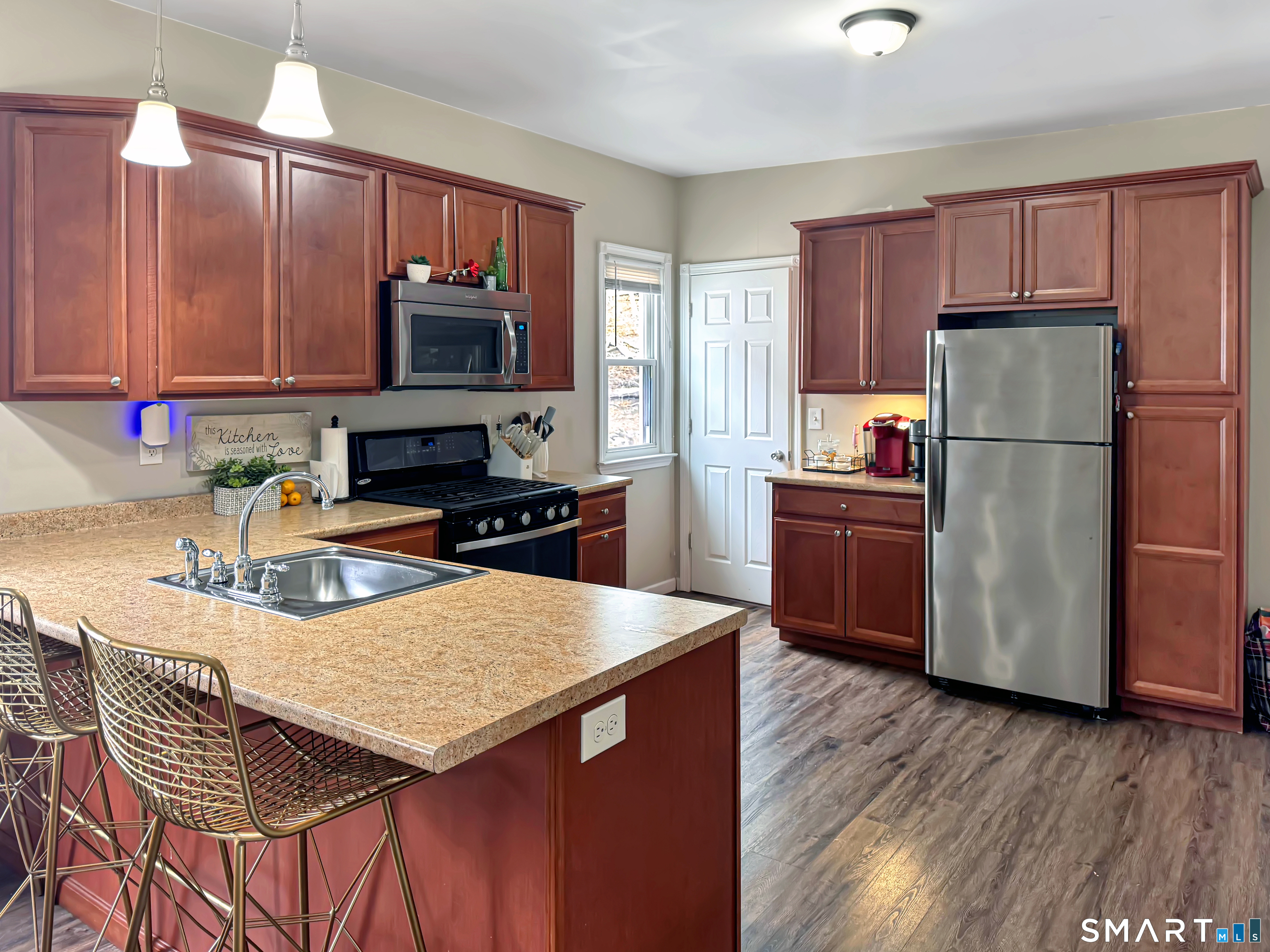 18 Columbia Street Ansonia, CT 06401 - Photo 2 of 16 a kitchen with granite countertop a stove a sink a refrigerator and a microwave