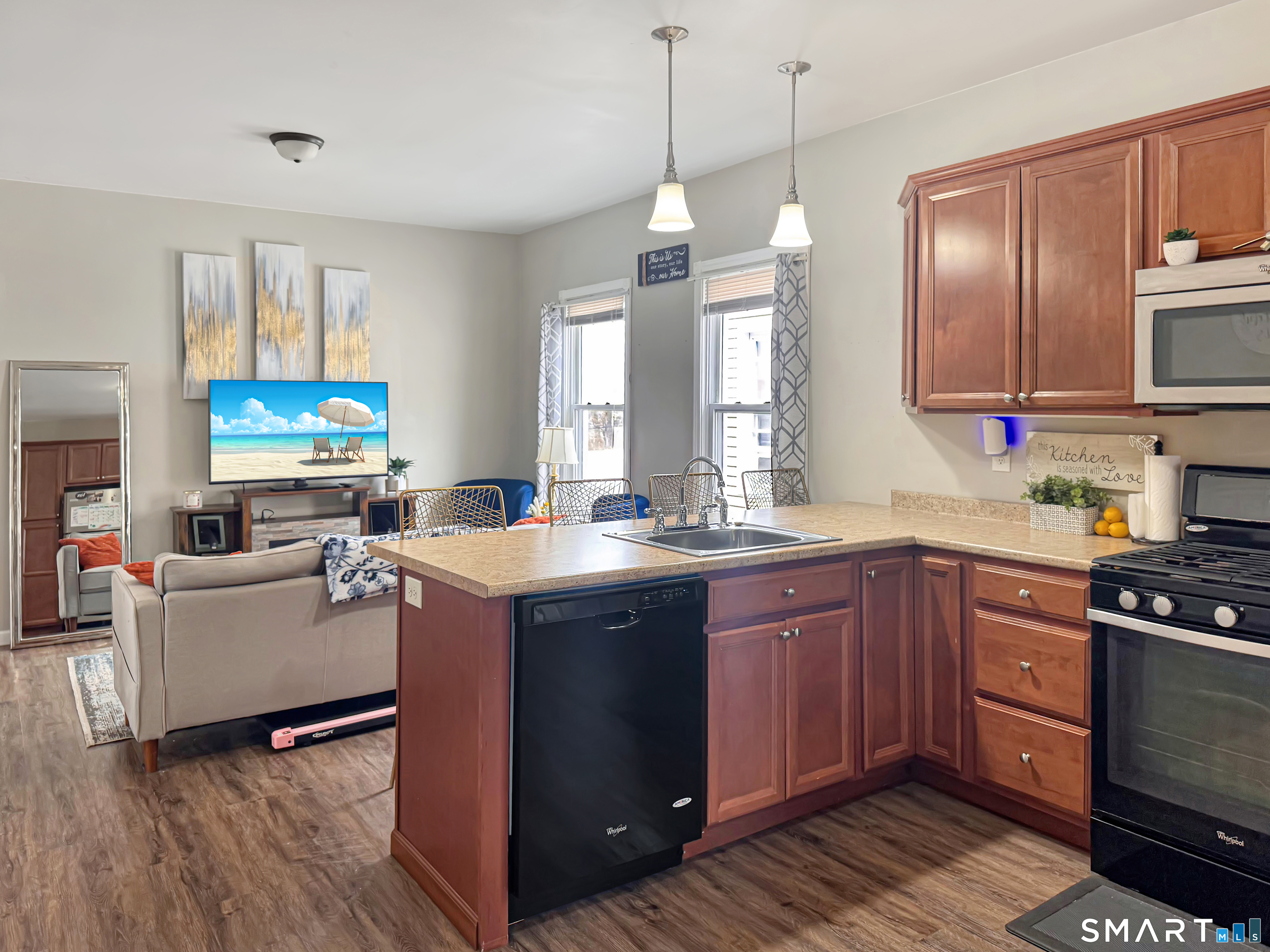 18 Columbia Street Ansonia, CT 06401 - Photo 3 of 16 a kitchen with stainless steel appliances granite countertop a stove a sink dishwasher a refrigerator and a dining table with wooden floor