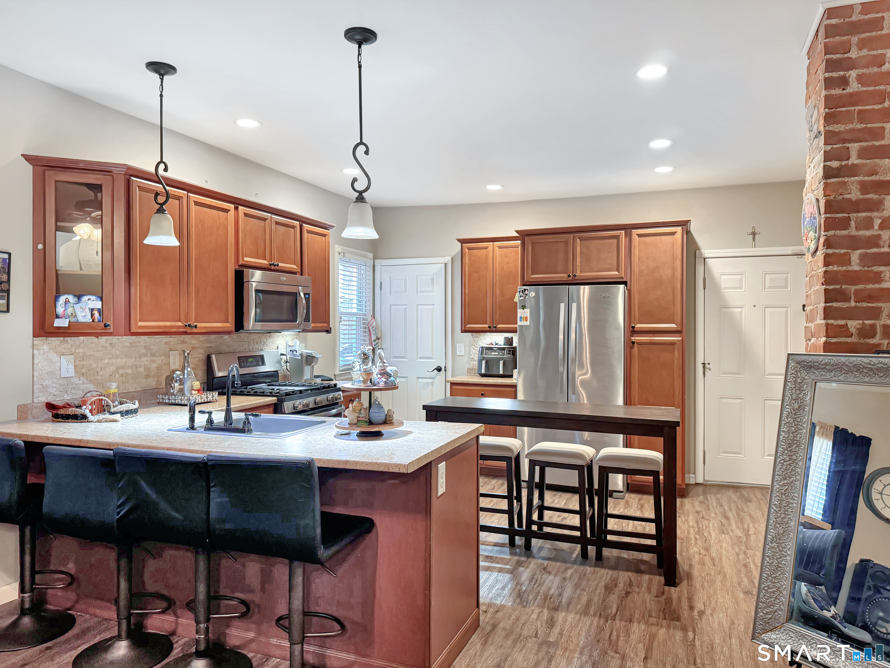 18 Columbia Street Ansonia, CT 06401 - Photo 5 of 16 a kitchen with stainless steel appliances a sink a stove a refrigerator dining table and chairs